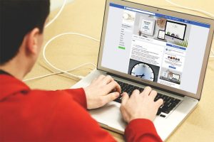 laptop user checking out a business on social media
